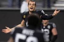 Raiders quarterback Derek Carr (4) warms up before the start of an NFL football game against th ...