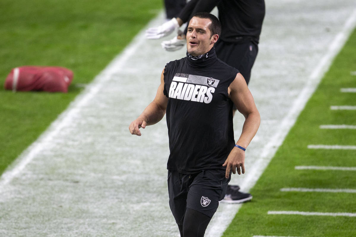 Raiders quarterback Derek Carr (4) runs off the field before an NFL football game against the M ...