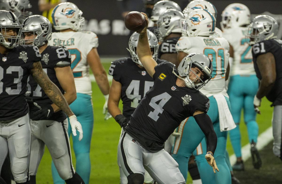 Raiders quarterback Derek Carr (4) spikes the ball after a touchdown versus the Miami Dolphins ...