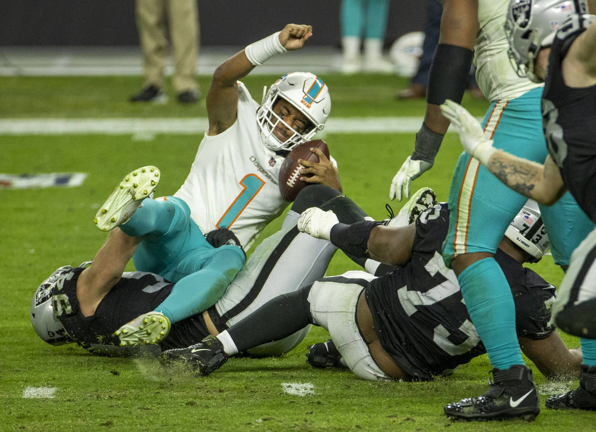 Raiders defensive end Carl Nassib (94) sacks Miami Dolphins quarterback Tua Tagovailoa (1) duri ...