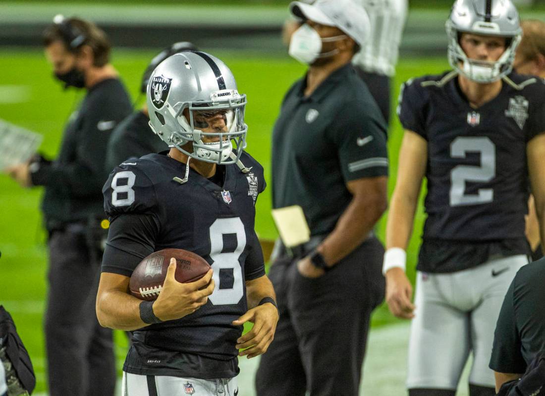 Raiders quarterback Marcus Mariota (8) wanders the sidelines versus the Miami Dolphins during t ...