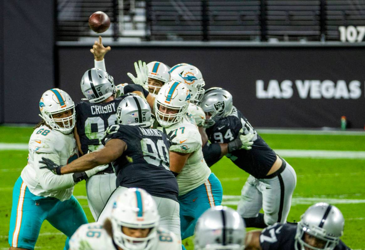 Miami Dolphins quarterback Ryan Fitzpatrick (14) gets off a touchdown pass in a hard rush from ...