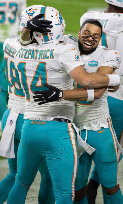 Miami Dolphins quarterback Ryan Fitzpatrick (14) celebrates with Miami Dolphins defensive back ...
