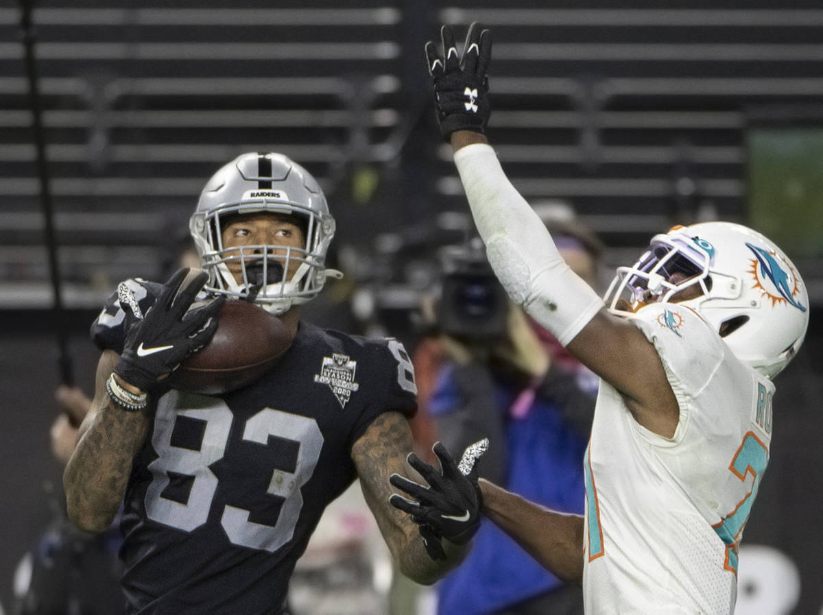 Raiders tight end Darren Waller (83) makes a one handed catch over Miami Dolphins free safety E ...