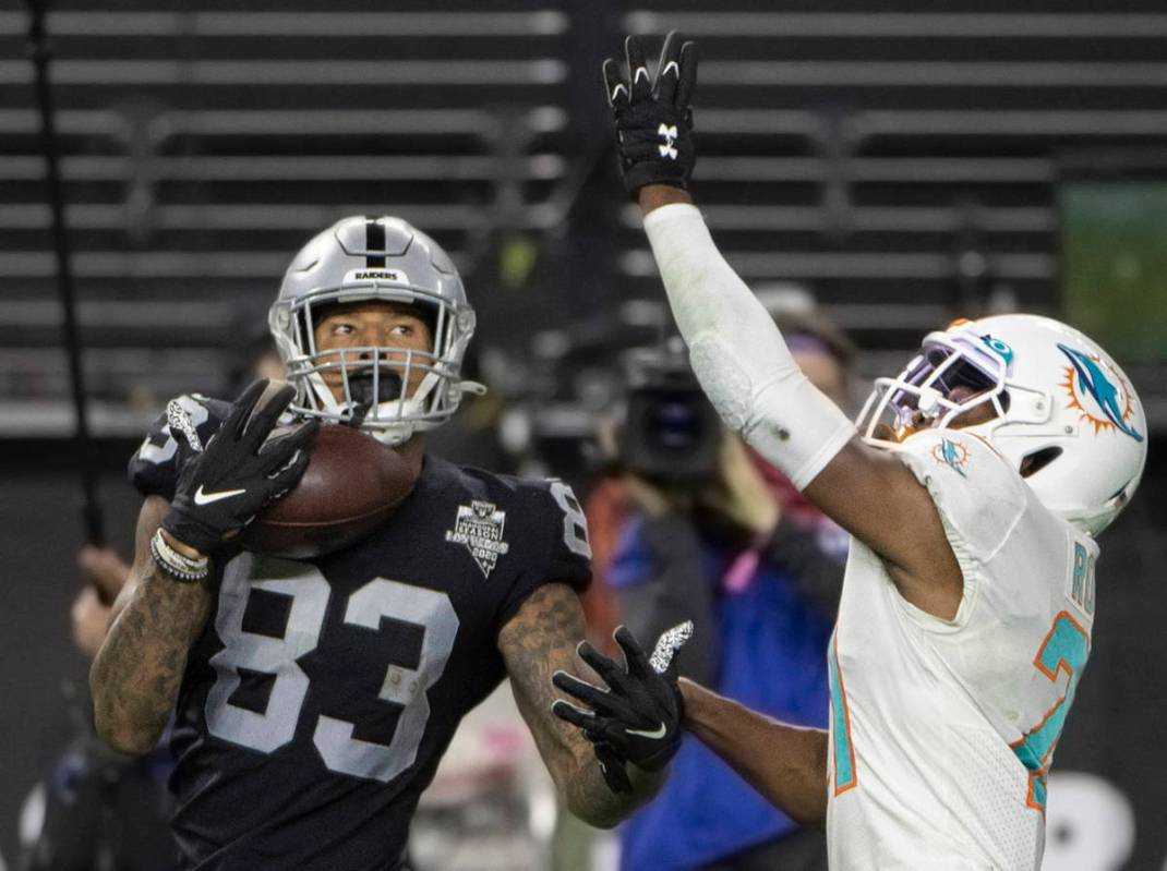 Raiders tight end Darren Waller (83) makes a one handed catch over Miami Dolphins free safety E ...
