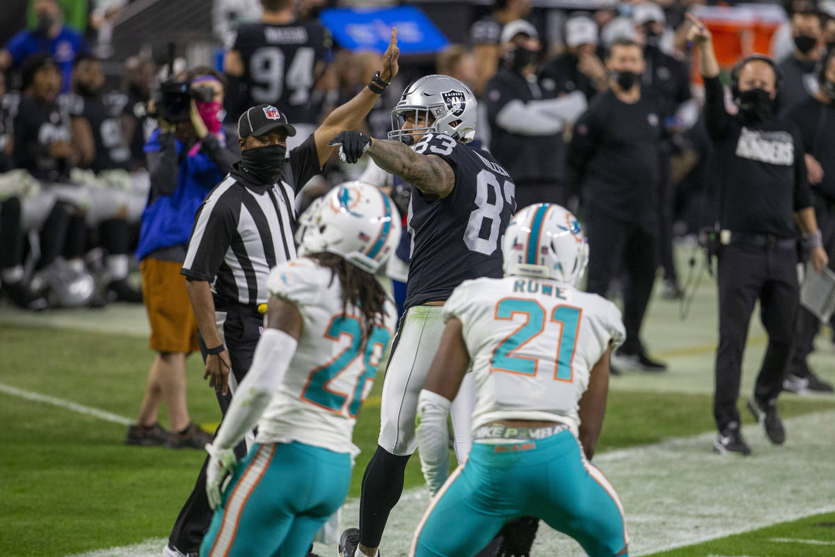 Raiders tight end Darren Waller (83) points for a first down after a catch made over Miami Dolp ...