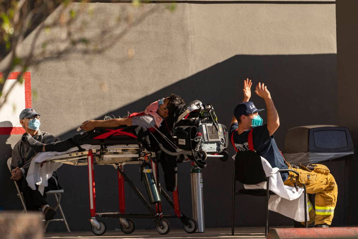 An unidentified patient receives oxygen on a stretcher while Los Angeles Fire Department parame ...