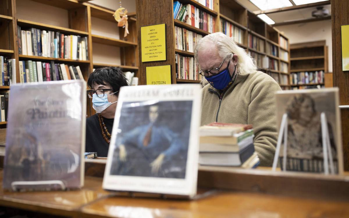 Gail Hees, left, and husband Randy shop at Amber Unicorn Books on the last business day of the ...