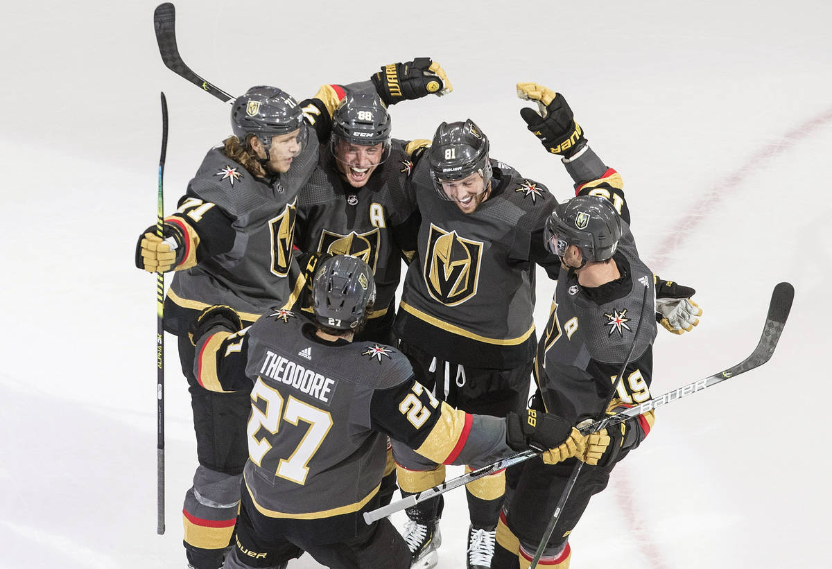 Vegas Golden Knights celebrate a goal during the third period of an NHL hockey playoff game aga ...