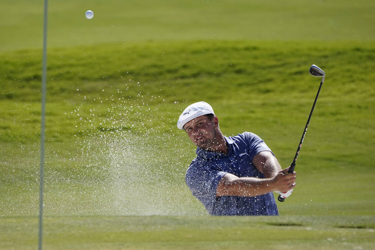 Bryson DeChambeau hits out of a bunker onto the ninth green during the final round of Shriners ...