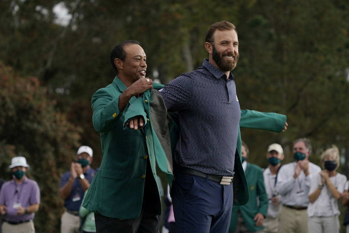 Tiger Woods, left and Dustin Johnson during the final round of the Masters golf tournament Mond ...