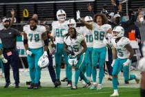 The Miami Dolphins sideline reacts after a game-winning field goal goes through the uprights du ...