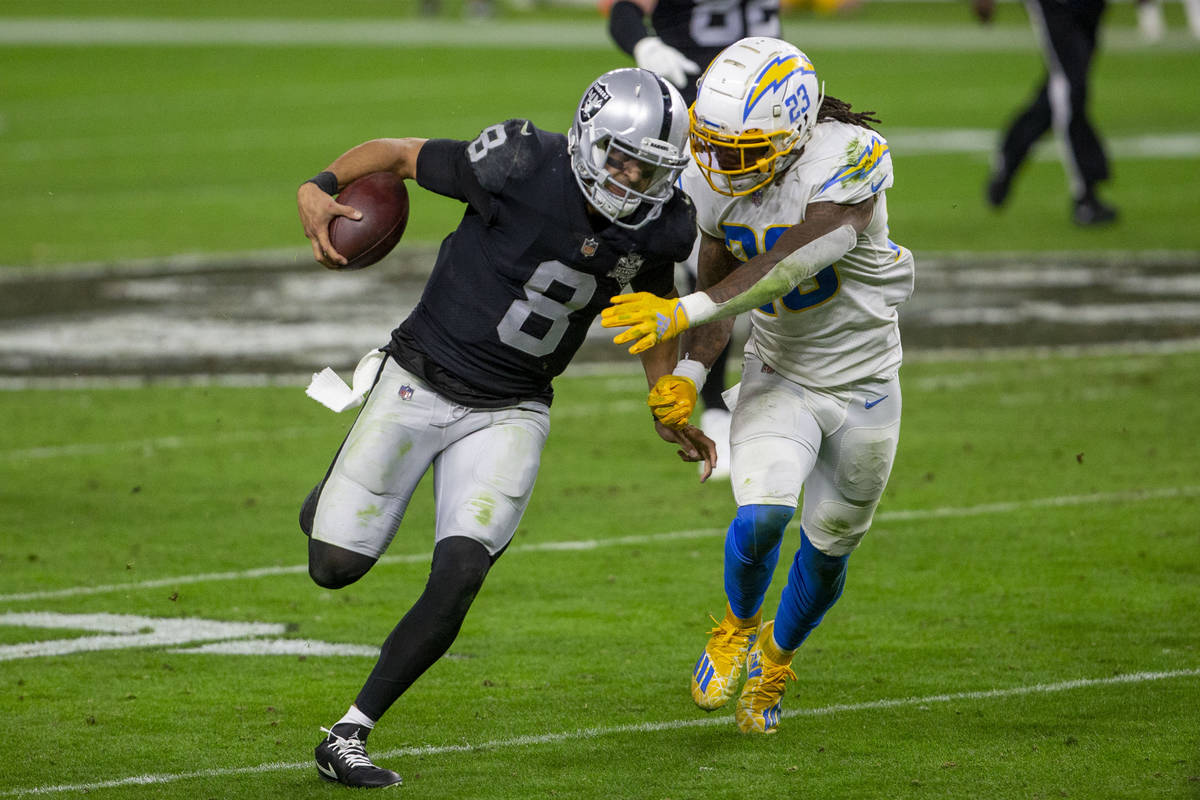 Raiders quarterback Marcus Mariota (8) runs with the football as Los Angeles Chargers strong sa ...