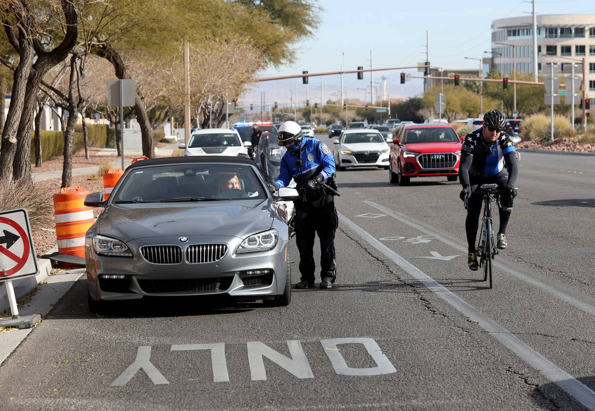 Police officers, including a North Las Vegas Police officer, front, pull over motorists as Sgt. ...