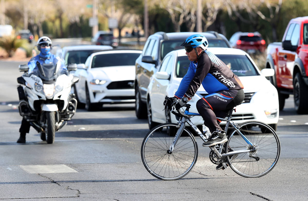 A cyclist rides across West Charleston Boulevard in Las Vegas in front of a North Las Vegas Pol ...