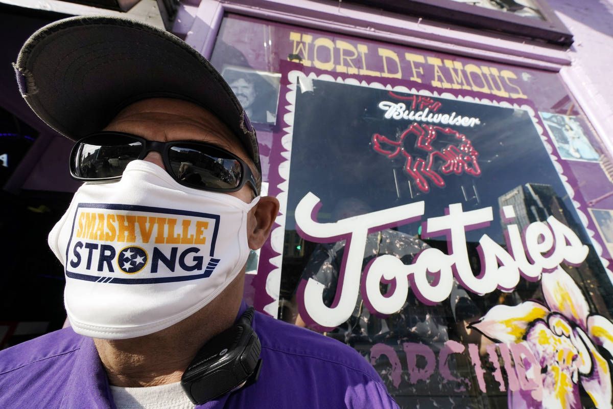 Jeffrey Susan, a security guard at Tootsies Orchid Lounge, wears a Nashville Strong face mask a ...
