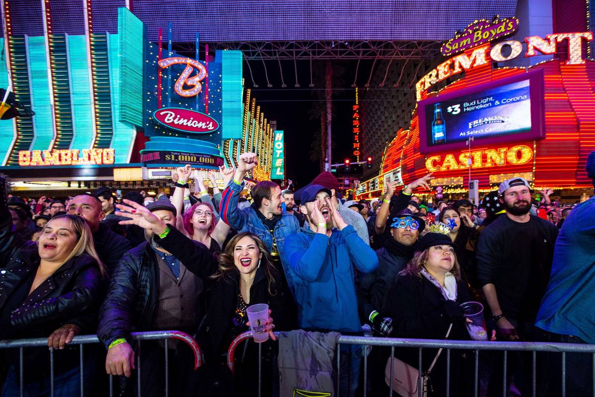 New Year's Eve revelers cheer by a stage at the Fremont Street Experience in downtown Las Vegas ...