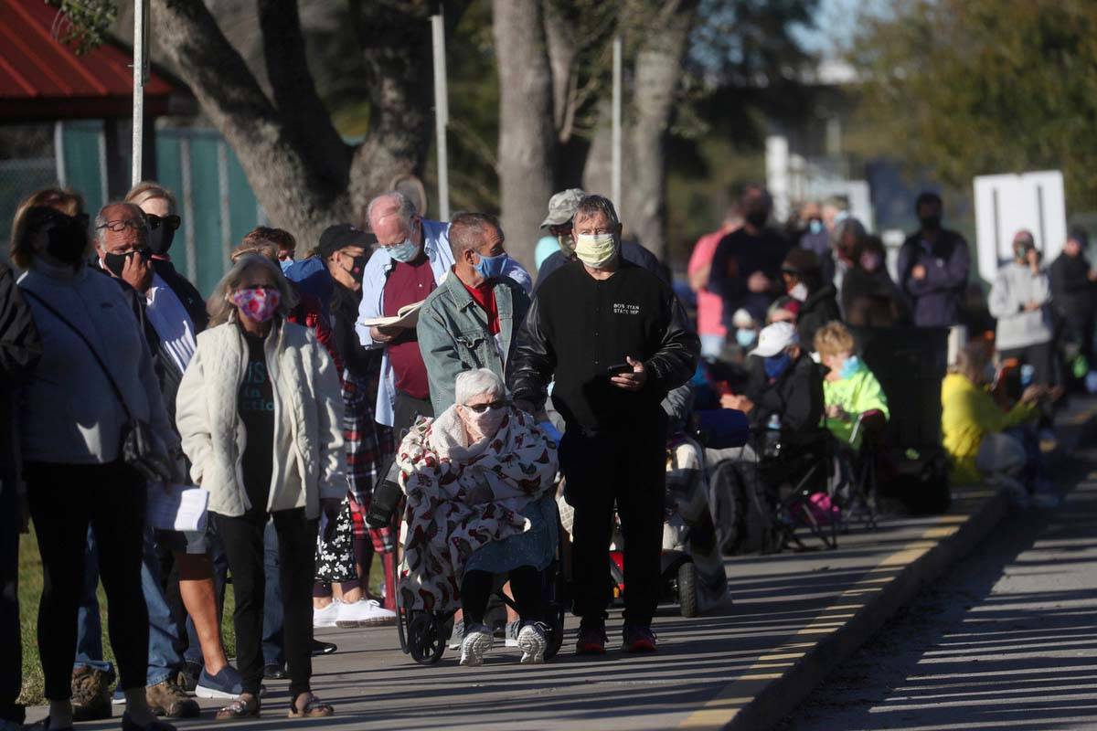 Hundreds of people wait in line Tuesday, Dec. 29, 2020, at the STARS Complex in Fort Myers, Fla ...