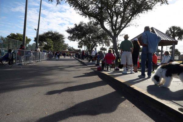 Hundreds of people wait in line Tuesday, Dec. 29, 2020, at the STARS Complex, in Fort Myers, Fl ...