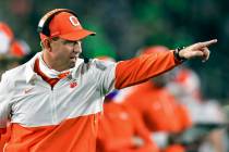 In this Saturday, Nov. 7, 2020, file photo, Clemson coach Dabo Swinney signals to his players d ...