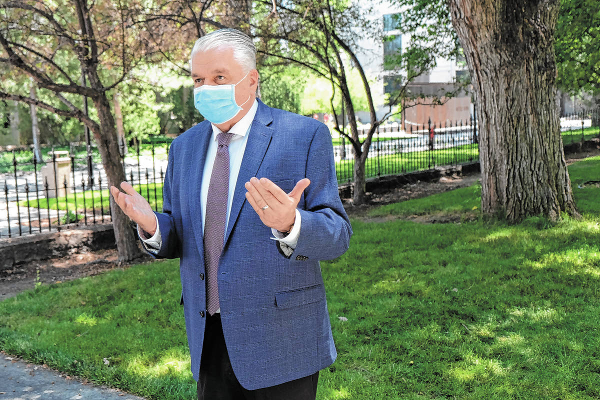 A masked Gov. Steve Sisolak speaks to reporters. (Bill Dentzer/Las Vegas Review-Journal)