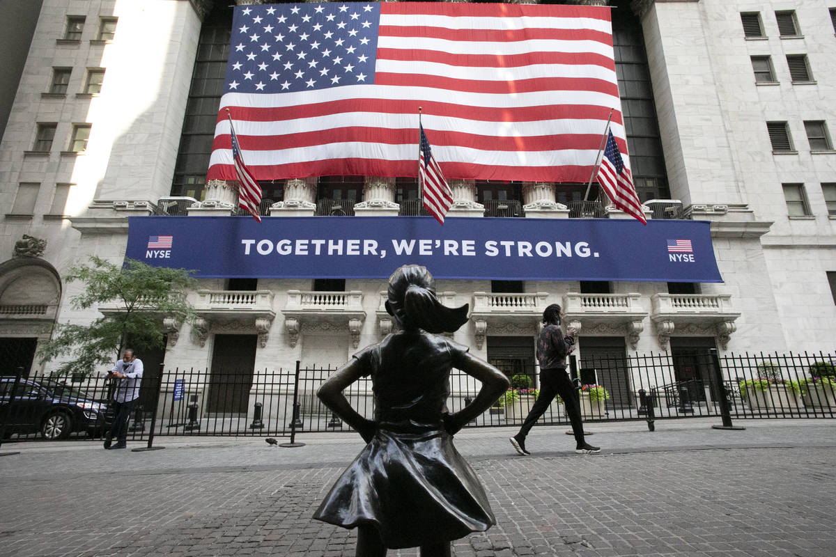 In this July 9, 2020 file photo, the Fearless Girl statue stands in front of the New York Stock ...