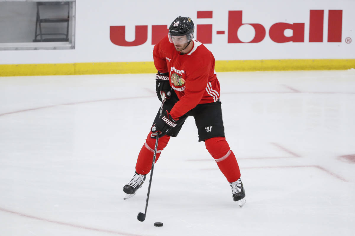 Chicago Blackhawks left wing Brandon Saad looks to pass the puck during NHL hockey practice at ...