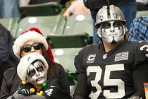A family of Oakland Raiders fans watch the team play against the Los Angeles Chargers during th ...