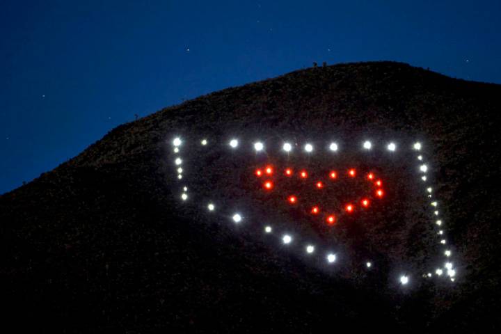 The solar lights shine brightly night falls about a Nevada light display atop of Black Mountain ...