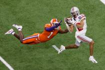 Ohio State wide receiver Chris Olave catches a touchdown pass in front of Clemson cornerback De ...
