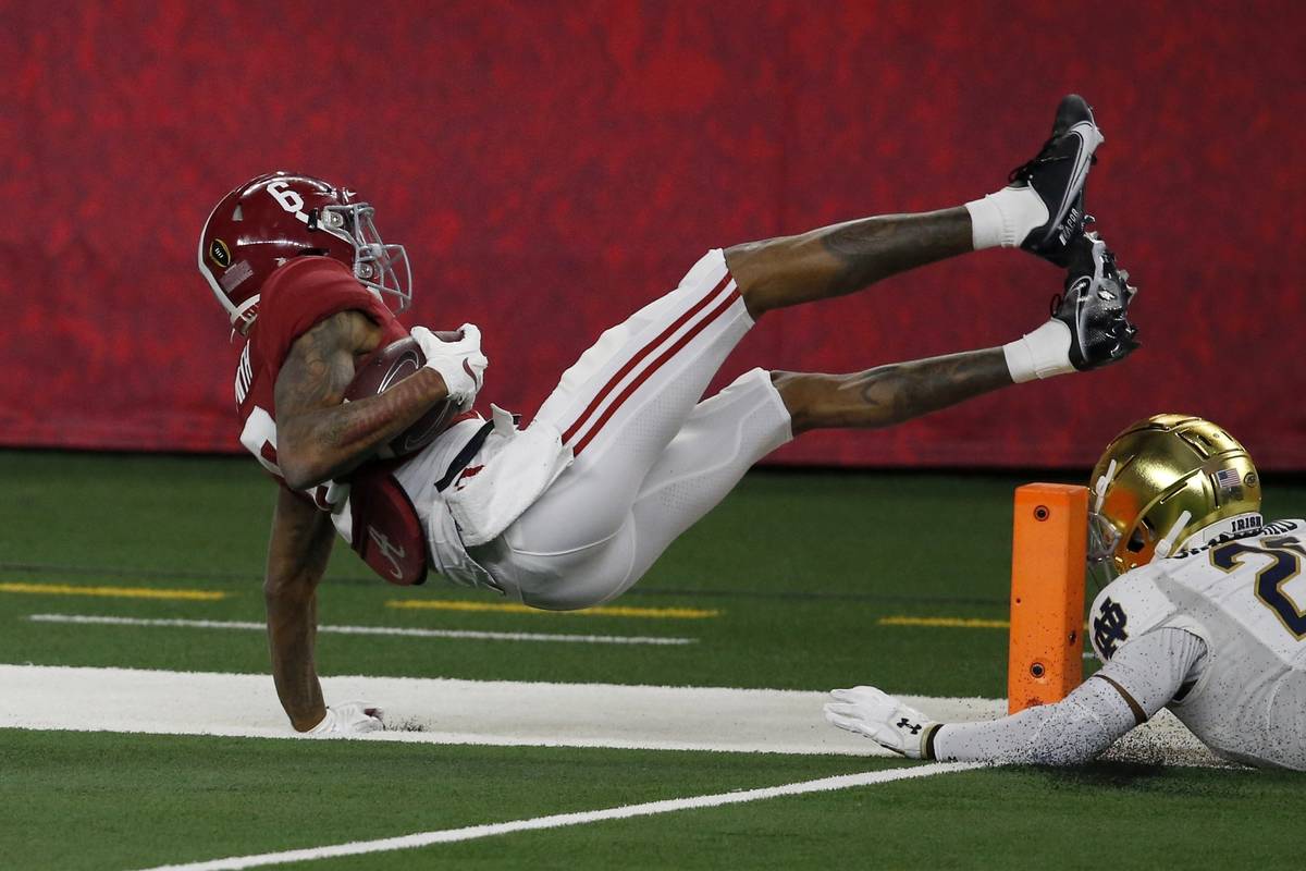Alabama wide receiver DeVonta Smith (6) leaps into the end zone or a touchdown after getting pa ...