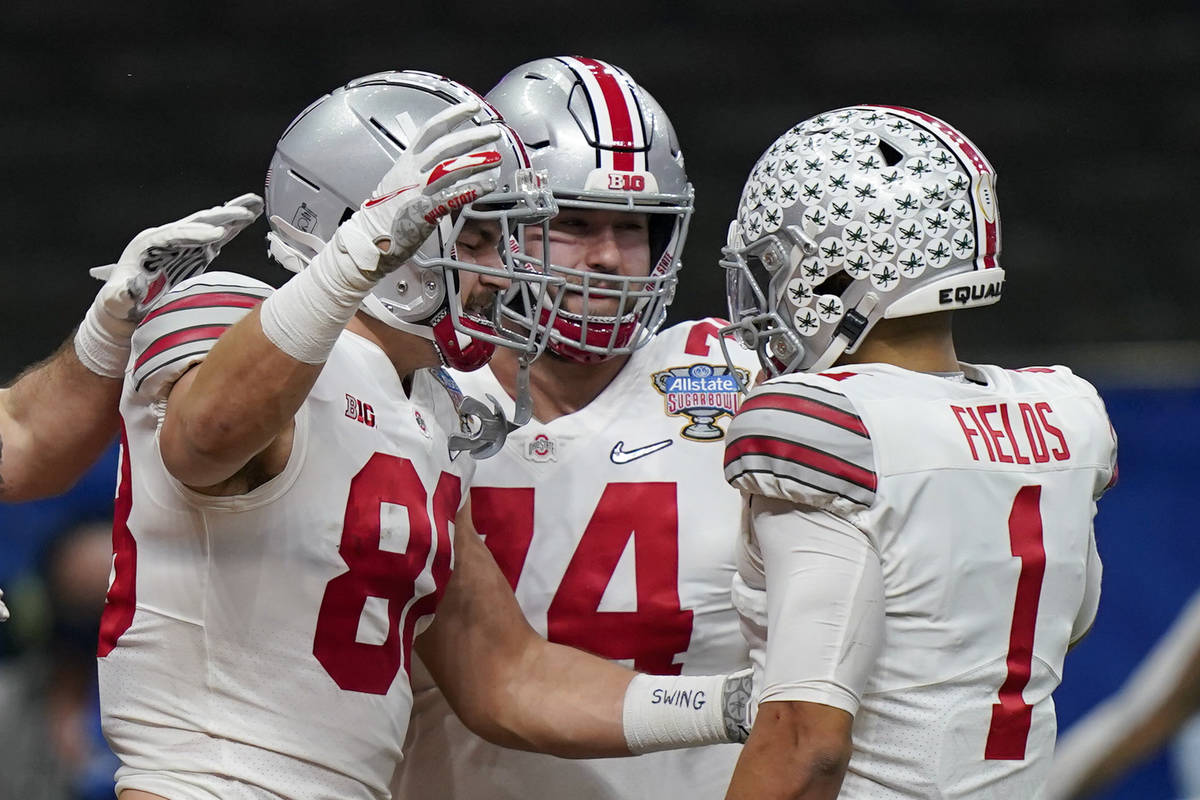 Ohio State tight end Jeremy Ruckert, left, celebrates his touchdown with quarterback Justin Fie ...