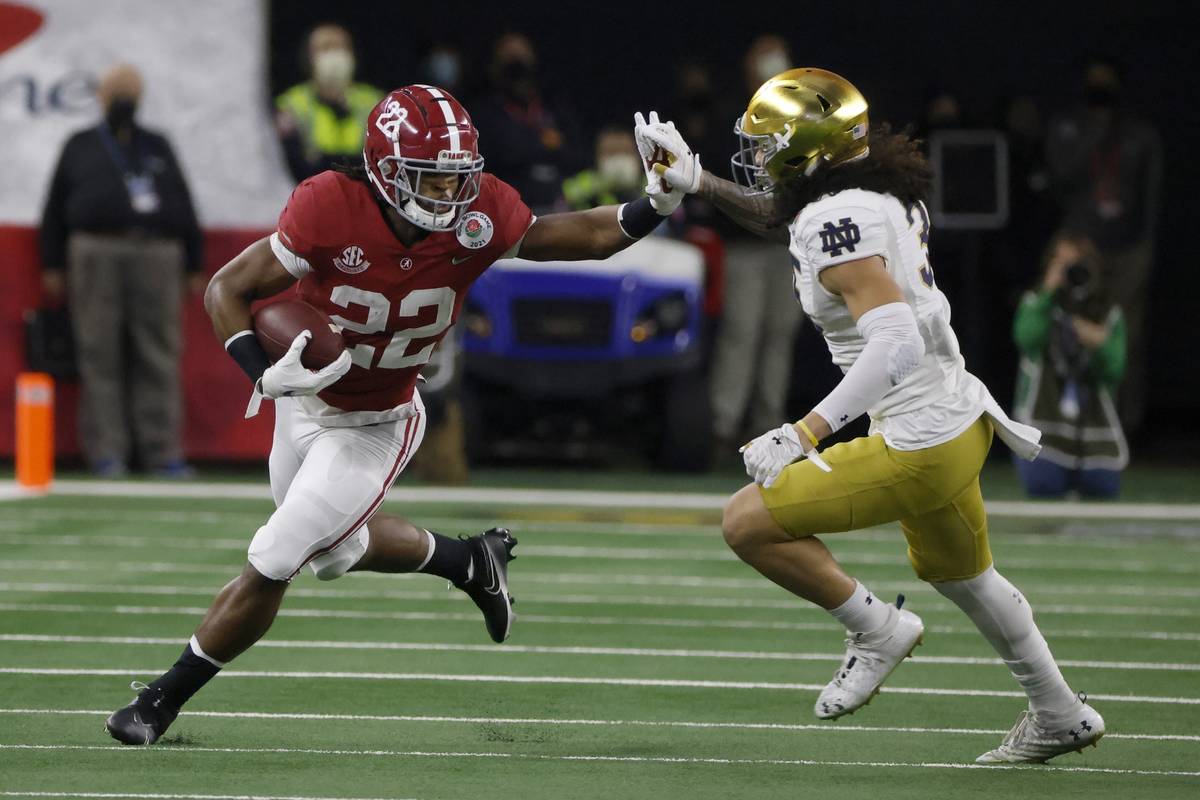 Alabama running back Najee Harris (22) fights off a tackle attempt by Notre Dame linebacker Mar ...