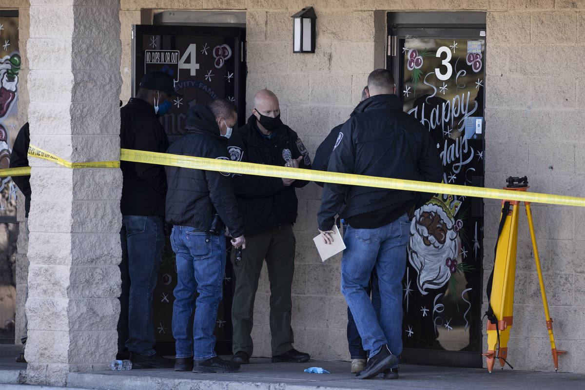 North Las Vegas police investigators work the scene of a fatal shooting near the intersection o ...