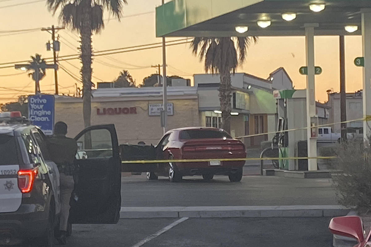 Las Vegas police surround a red Dodge car in front of a Sinclair gas station shortly after 6:30 ...