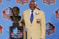 FILE - In this Aug. 7, 2010 file photo, Floyd Little poses with his bust after enshrinement in ...