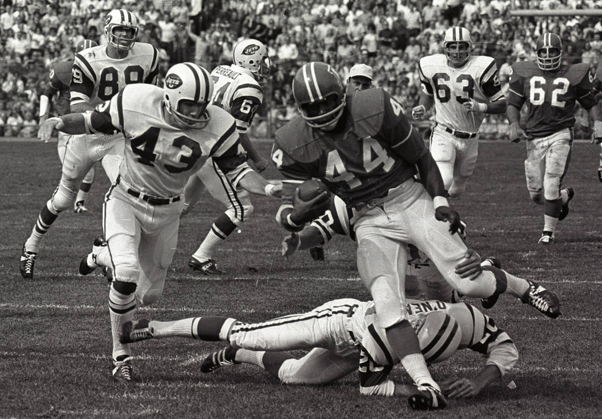 FILE - In this Sept.1969 file photo, Denver Broncos' Floyd Little avoids the tackle of New York ...