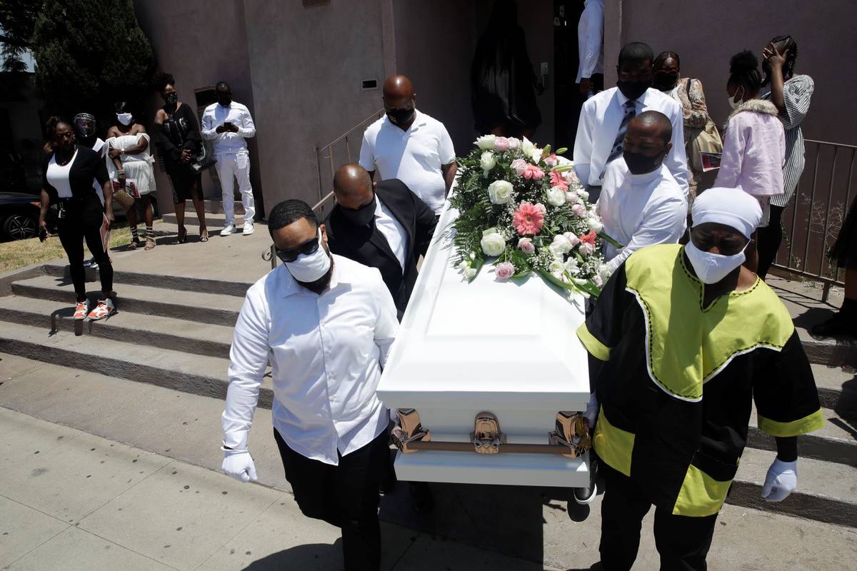 Pallbearers carry a casket with the body of Lydia Nunez, who died from COVID-19, after a funera ...