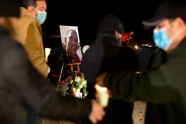 Attendees of a vigil for Eric Echevarria, a 52-year-old father and husband who was killed in a ...