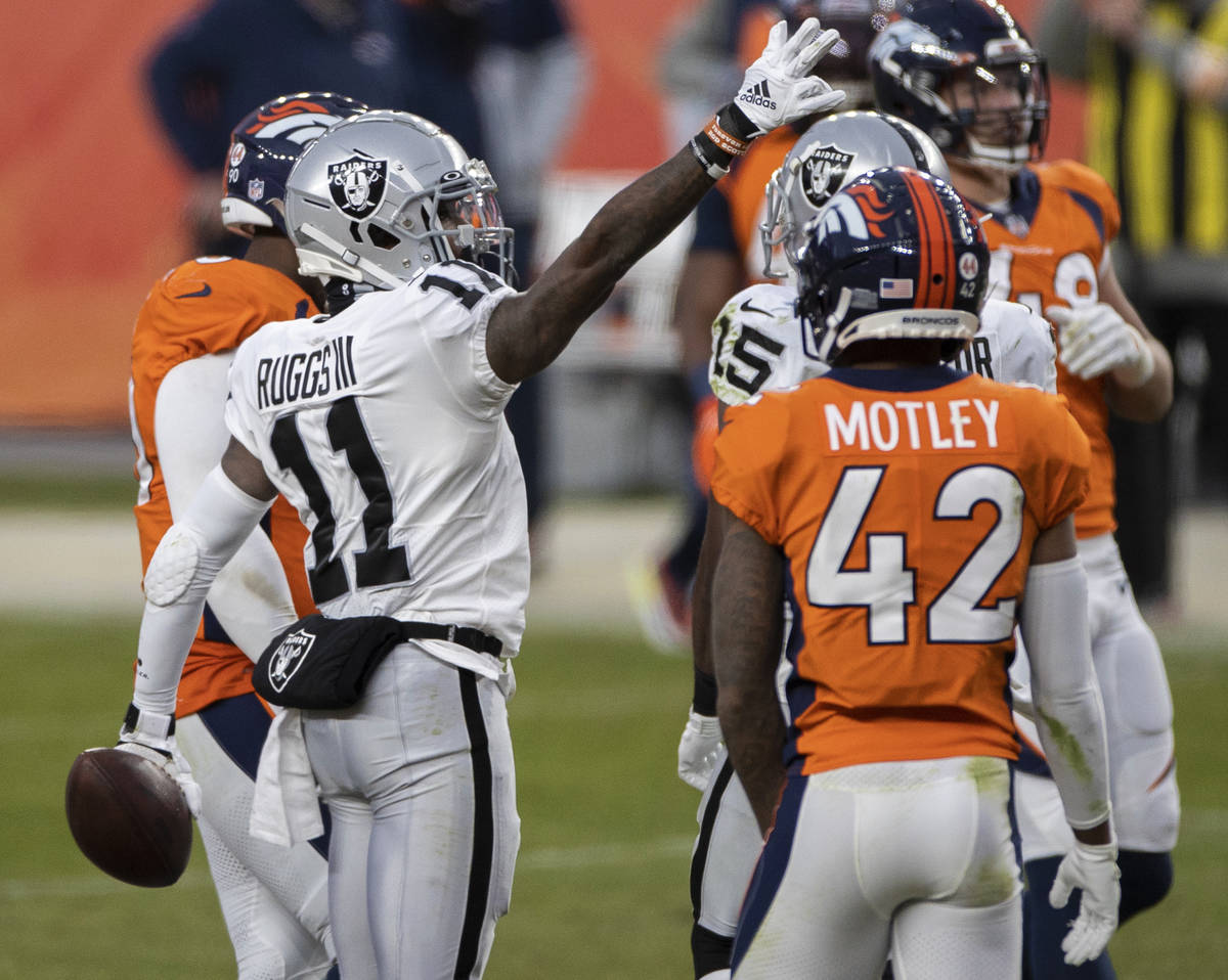 Raiders wide receiver Henry Ruggs III (11) signals a first down in the face of Denver Broncos c ...