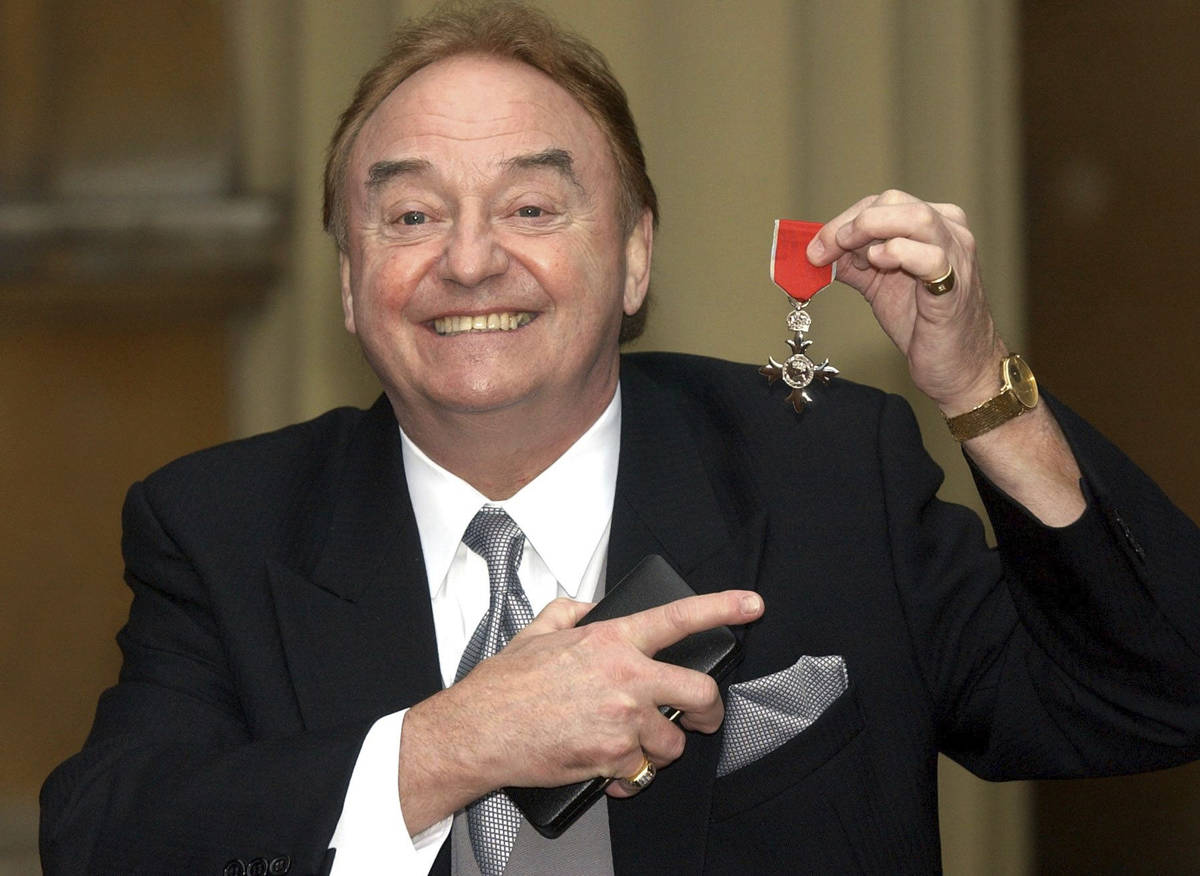 FILE - In this Dec. 12, 2003 file photo, Gerry Marsden holds his MBE. Gerry Marsden, the Britis ...