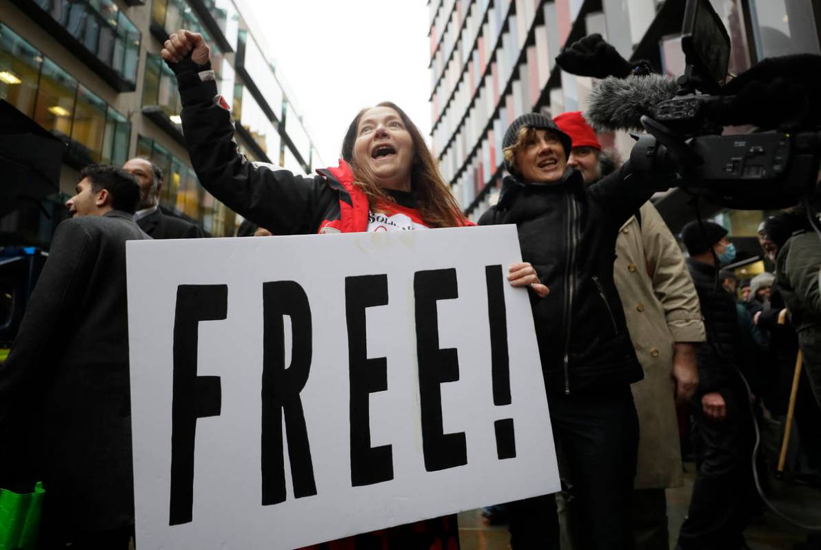 Julian Assange supporters celebrate after a ruling that he cannot be extradited to the United S ...