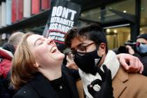 Julian Assange supporters celebrate after a ruling that he cannot be extradited to the United S ...