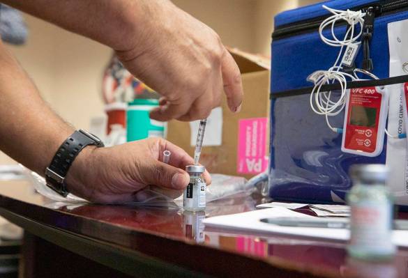 The North Las Vegas Fire Department administers its first batch of a COVID-19 vaccines to first ...
