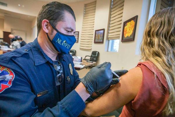 The North Las Vegas Fire Department's fire equipment specialist Victor Mancilla, left, administ ...