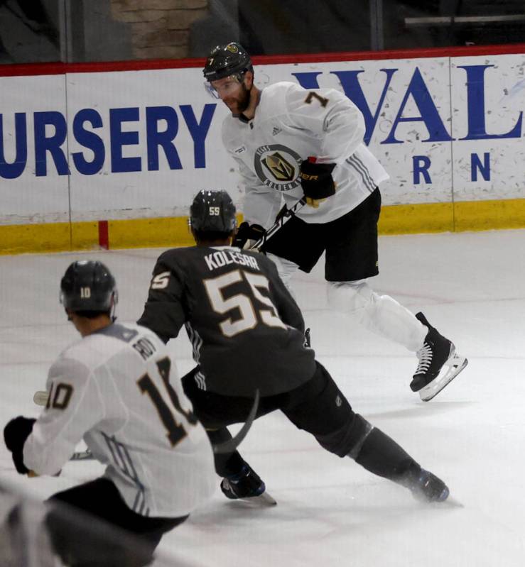 Golden Knights defenseman Alex Pietrangelo (7), top, looks to move the puck past forward Keegan ...