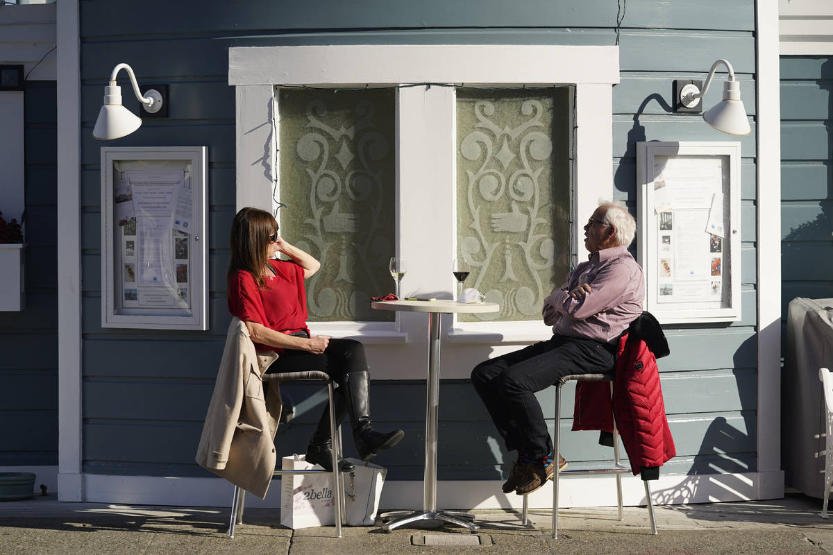 A couple dines outdoors at Scoma's restaurant Friday, Dec. 4, 2020, in Sausalito, Calif. (AP Ph ...
