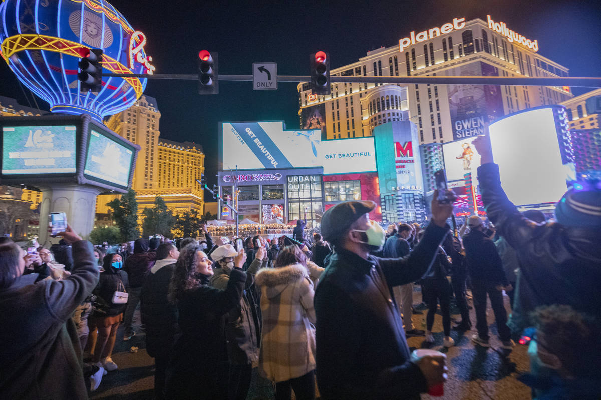 Individuals gather to celebrate New Year's Eve on the Las Vegas Strip, Thursday, Dec. 31, 2020. ...