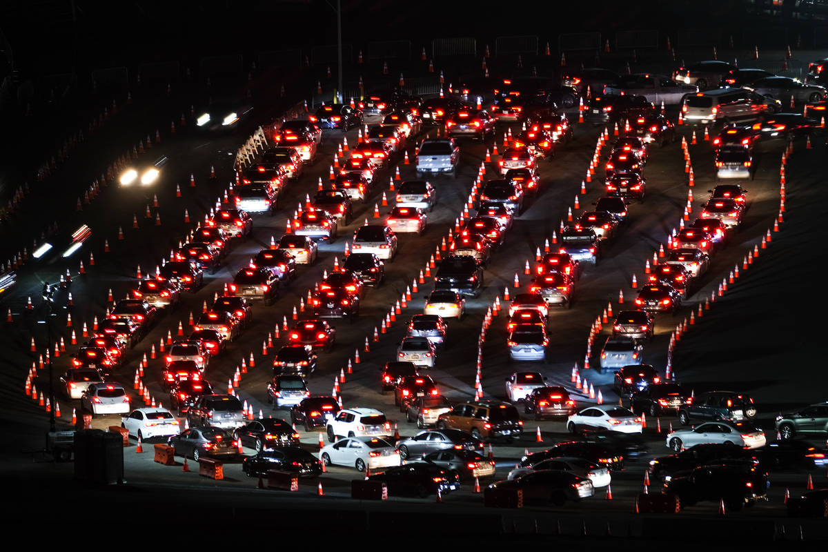 Motorists line up to take a coronavirus test in a parking lot at Dodger Stadium, Monday, Jan. 4 ...