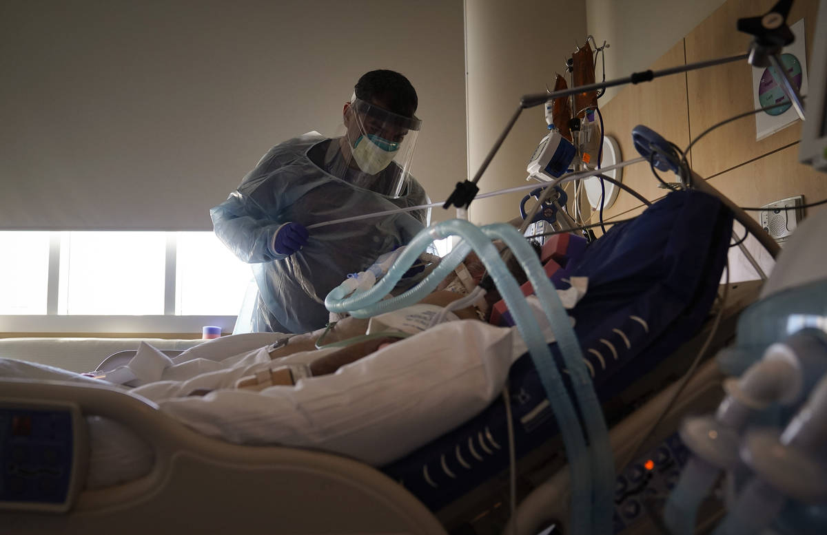 In a Dec. 22, 2020, file photo, Dr. Mher Onanyan tends to a COVID-19 patient at Providence Holy ...